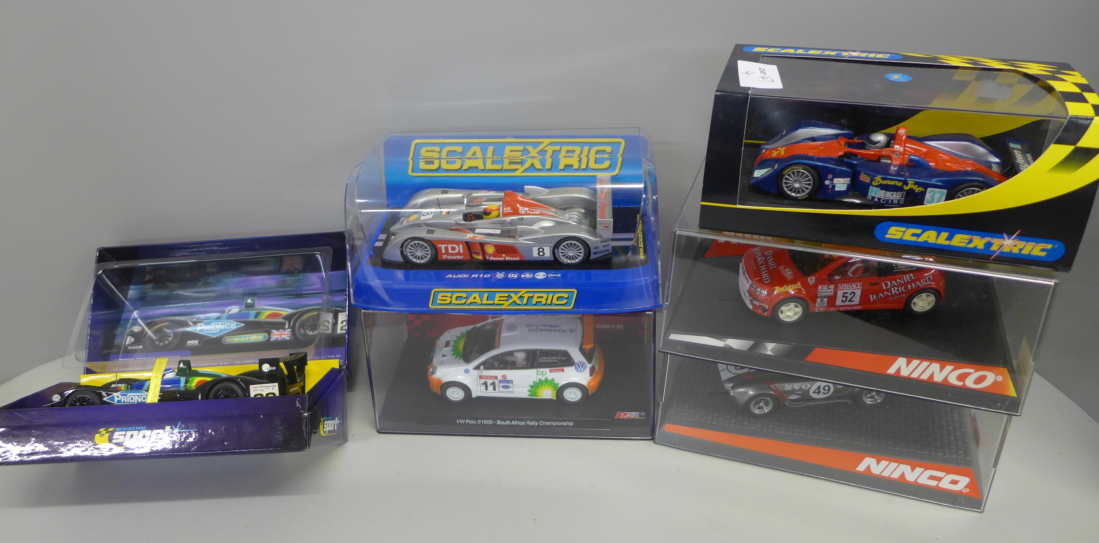 Six slot car vehicles, including Scalextric and Winco