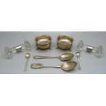 Two silver mounted glass kinfe rests, two silver spoons, a pair of silver salts and a pair of silver