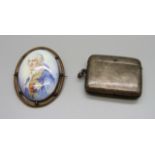 A silver vesta case and a brooch