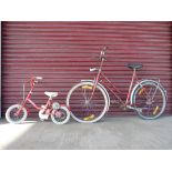 A vintage Dutch lady's bicycle and a child's bicycle with stabilisers