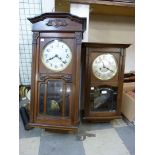 An oak wall clock and a mahogany wall clock