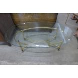 An Italian style brass and oval glass topped coffee table