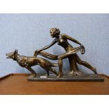 An Art Deco style figure of a girl with dog