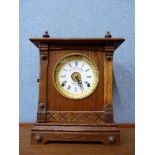 An early 20th Century oak mantel clock, the dial signed Fattorini & Sons, Bradford