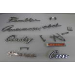 A collection of American car badges