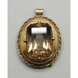 A yellow metal brooch/pendant , set with a smoky quartz stone, 26g, stone 22mm x 28mm