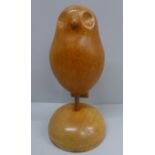 A carved wooden owl on plinth, 25cm