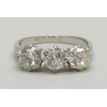 A platinum set 1930's three stone diamond ring, size O, 2.9g, diamonds circa 0.65 carat each,