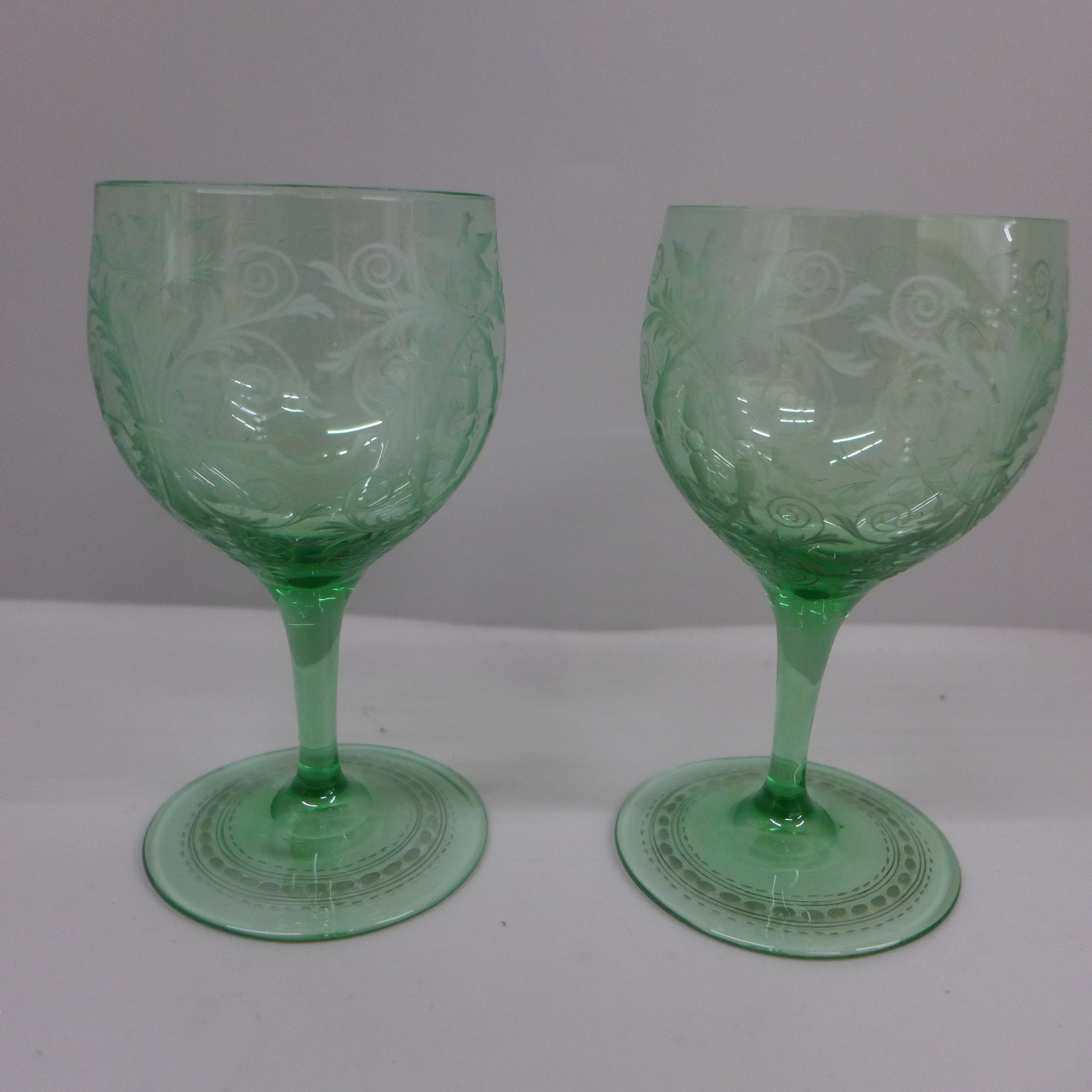 A pair of green wine glasses, engraved with rococo design, circa 1880, possibly Austro-Hungarian