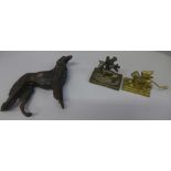 A cast metal figure of a Borzoi, a/f and two brass figures, winged dog and lamb by a tree