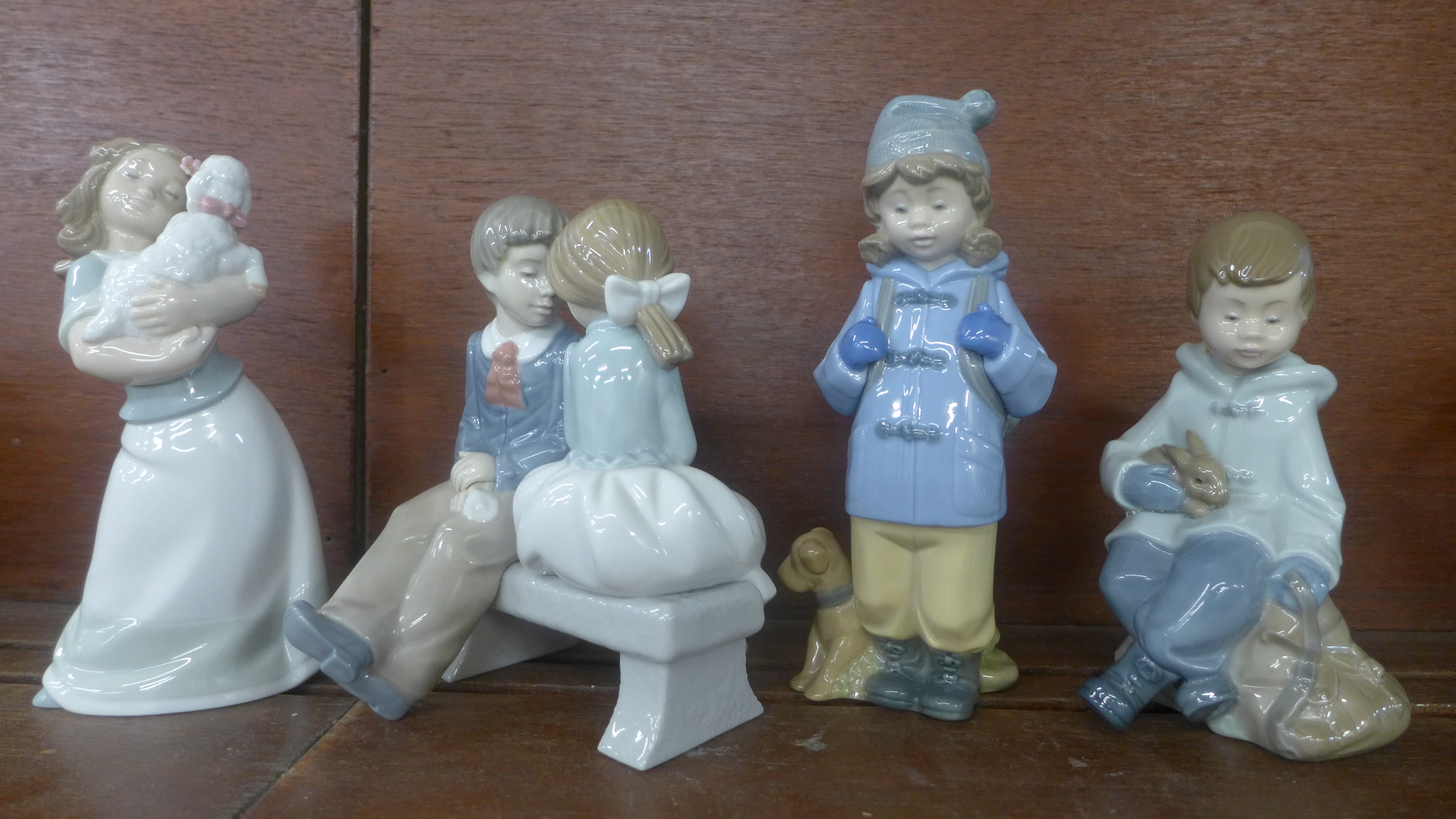 Four Nao figurines, one a/f