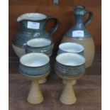 A 1970's Anthony Richards Penderleath St. Ives pottery wine jug and four goblets, a/f