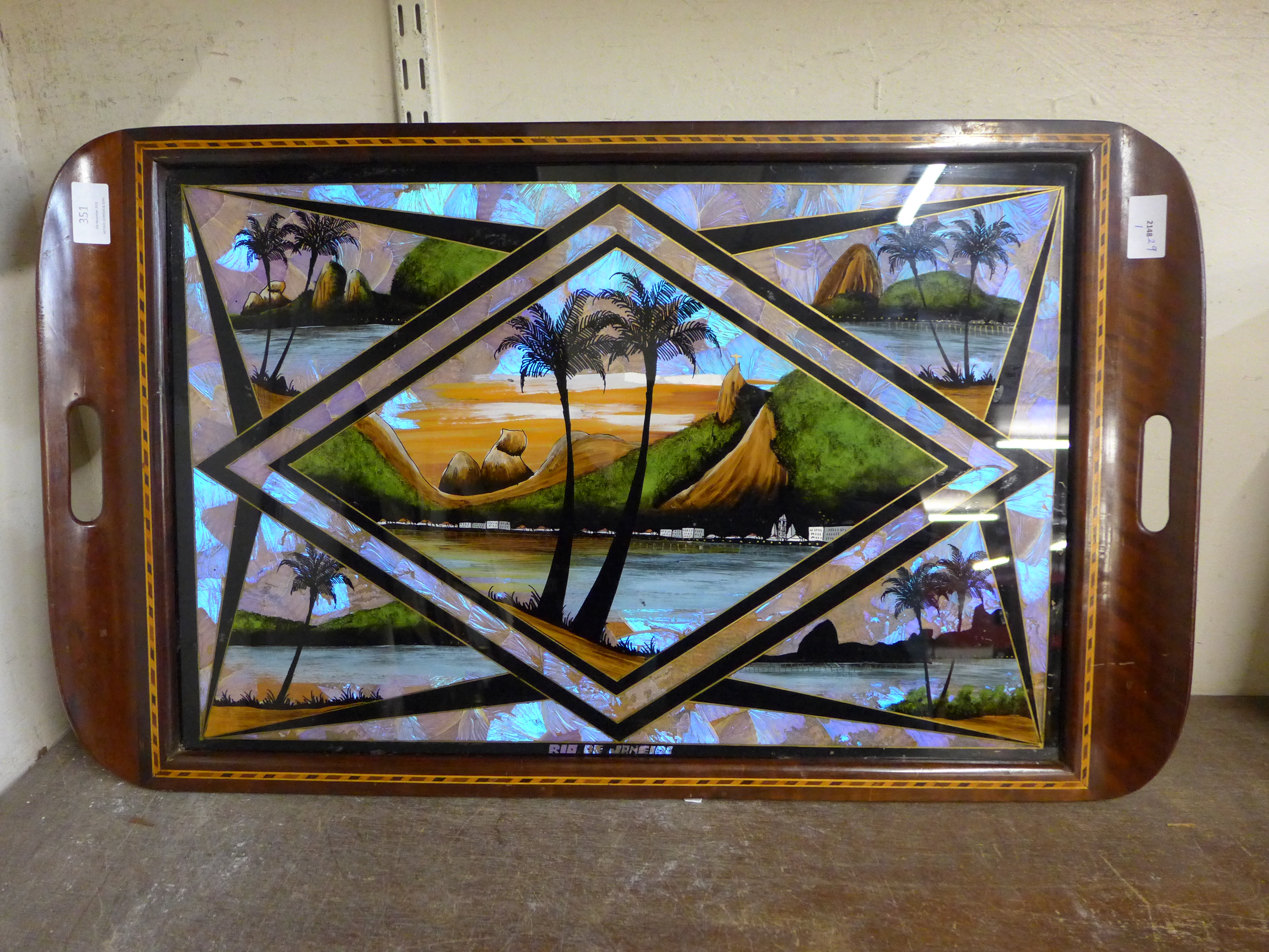 A Brazilian inlaid mahogany tray with reverse painted glass and butterfly wings