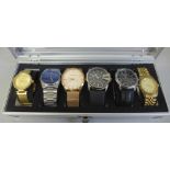 An aluminium watch storage box with six wristwatches including Guess, Storm and Diesel