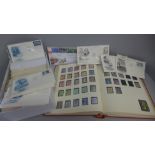 An album of British stamps and a box of first day covers