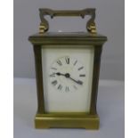 A gilt brass carriage clock with key