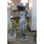 A concrete garden figure of semi nude female