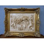 An Italian style reconstituted marble plaque of cherubs, framed