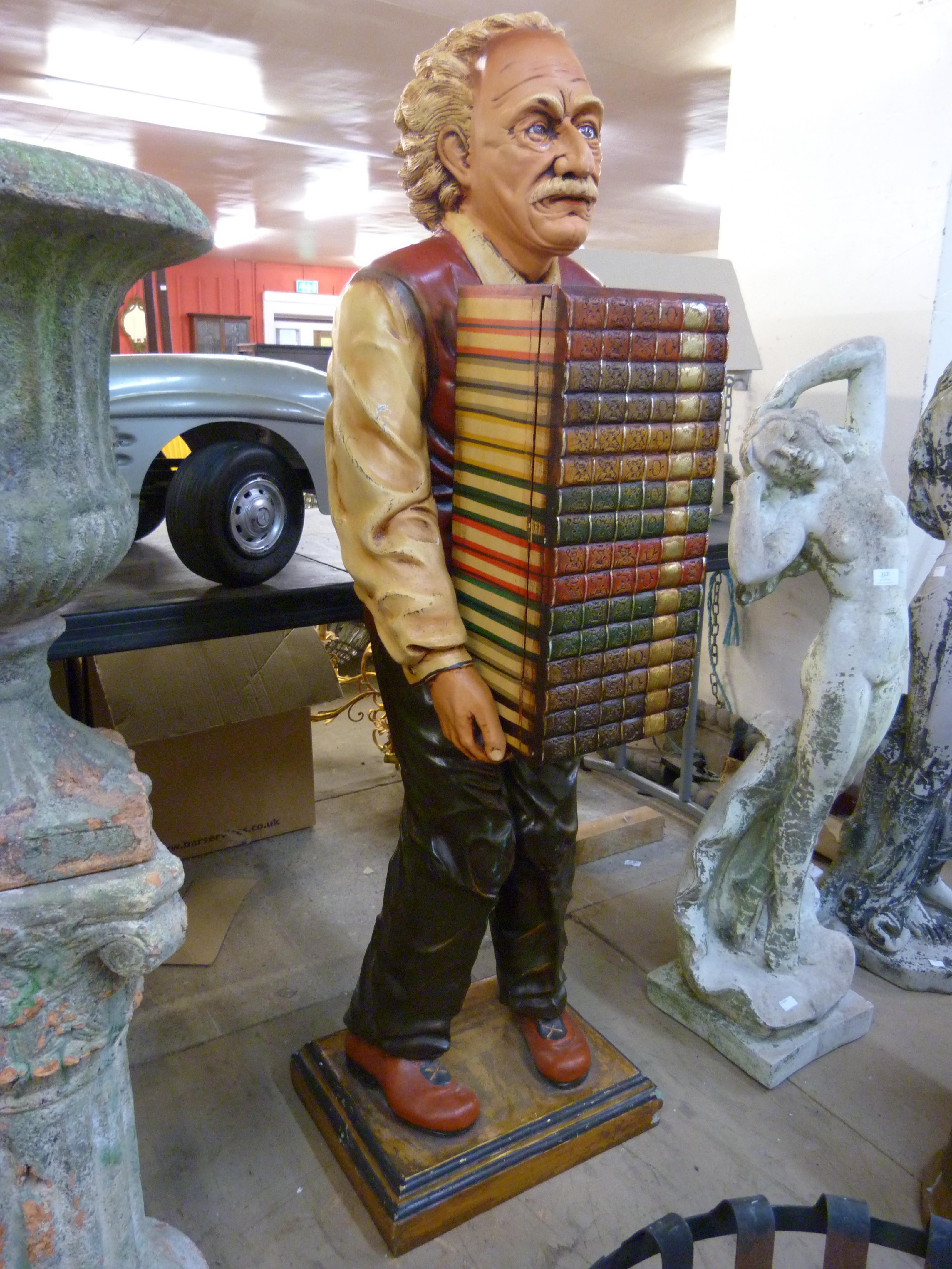 A painted figural fibreglass cabinet, in the form of Albert Einstein holding books