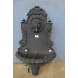 A cast iron wall mounted water font with circulating water pump