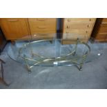 An Italian style brass and oval glass topped coffee table