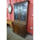 An Edward VII oak and stained glass two door bookcase