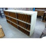 A large industrial painted pigeonhole cabinet, 100cms h, 222cms w, 46cms d