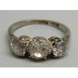 An 18ct gold, three stone diamond ring, the centre stone approximately 0.75 carat weight, 3.7g, P