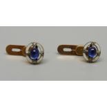 A pair of small yellow metal, cabochon sapphire, diamond and enamel studs, 3.5g