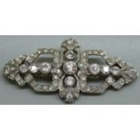 A white metal and diamond set Art Deco brooch/collar clips, the centre stone approximately 0.75ct