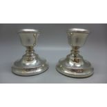 A pair of small silver candlesticks