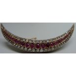 A large c1900 crescent moon shaped brooch set with rubies and diamonds, 16.7g, 8.5cm