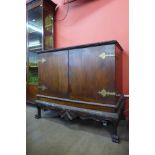 An Edward VII Chippendale Revival carved mahogany press cupboard