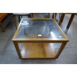 A teak nest of tables and a teak and glass topped coffee table