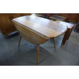 An Ercol Blonde elm and beech Windsor drop leaf table