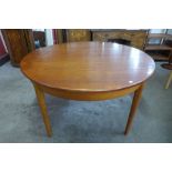 A Jentique teak circular extending dining table