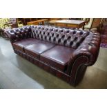 A burgundy leather Chesterfield settee