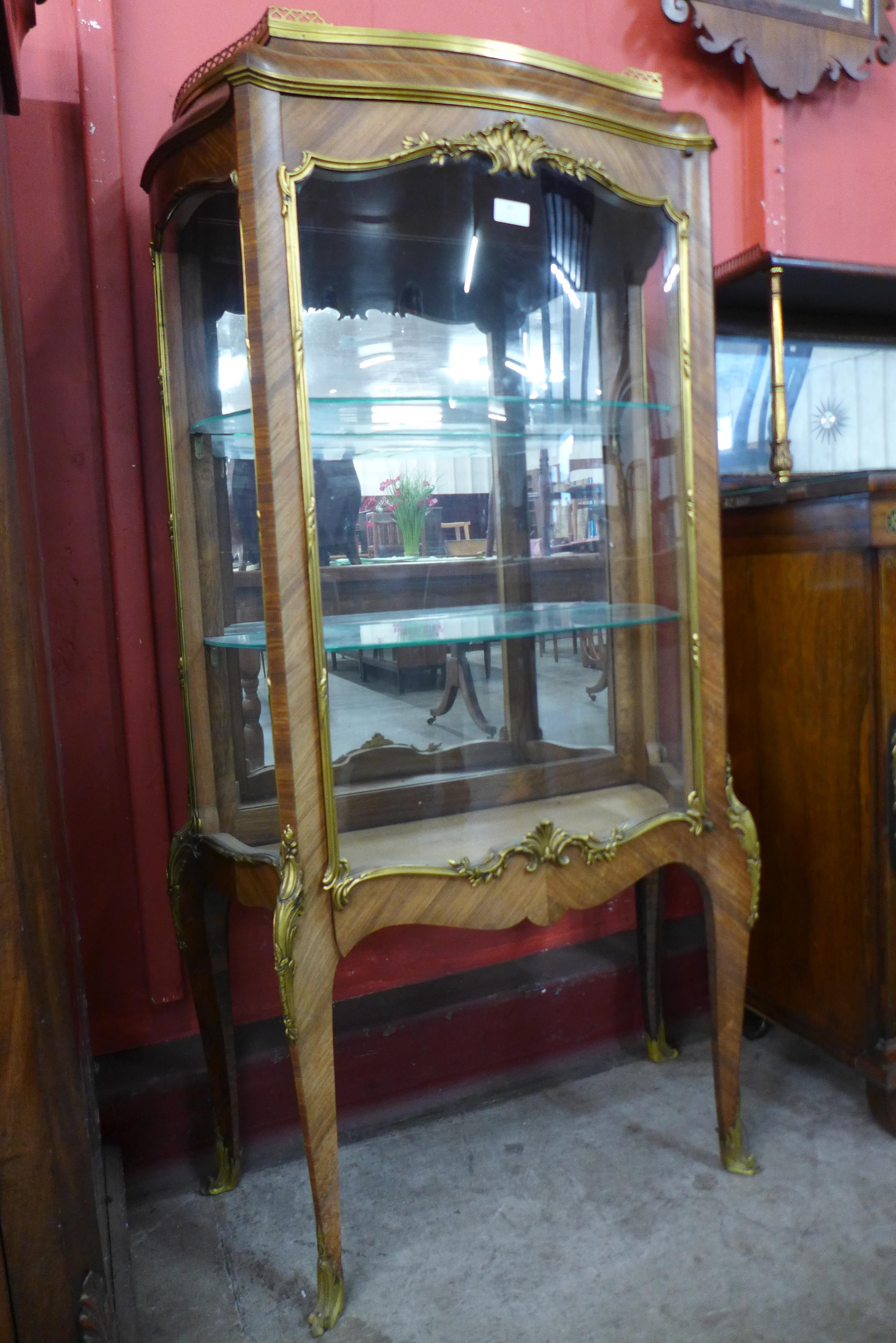 A 19th Century French rosewood and ormolu mounted serpentine vitrine, 134cms h, 74cms w, 32cms d