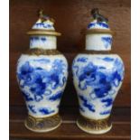 A pair of antique blue and white crackle glaze Chinese vases with figural decorated covers, 16cms,