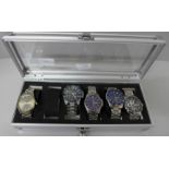 Five Sekonda wristwatches in a metal display case