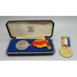 A Queen Elizabeth II Fire Service medal, boxed and a local King Geoge VI Coronation medal