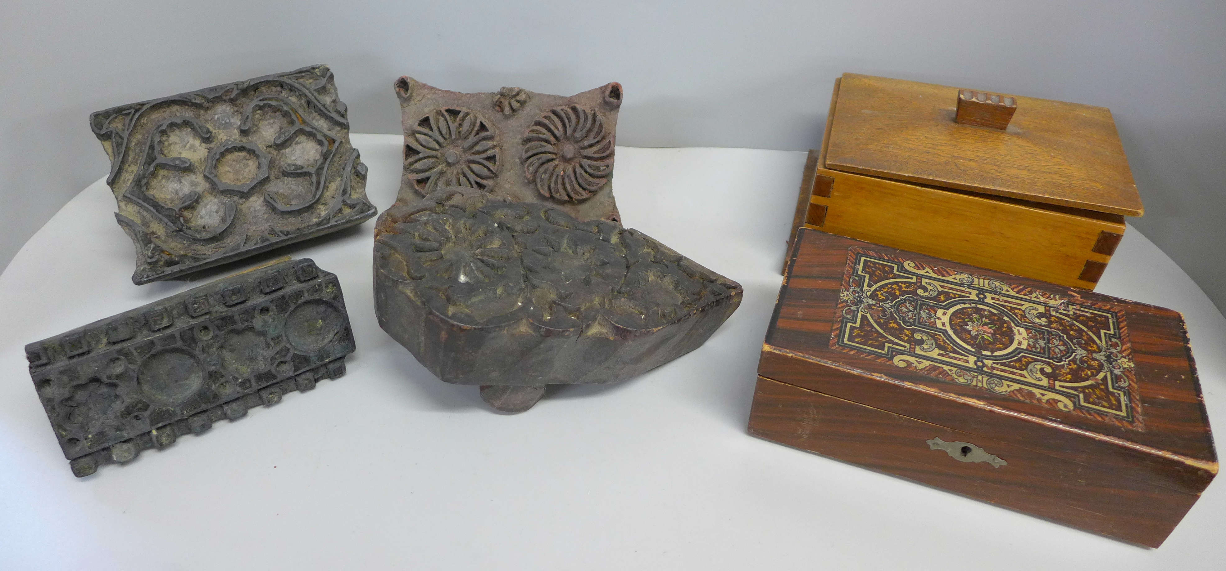 Four printing blocks and two wooden boxes, one with decorative inlay