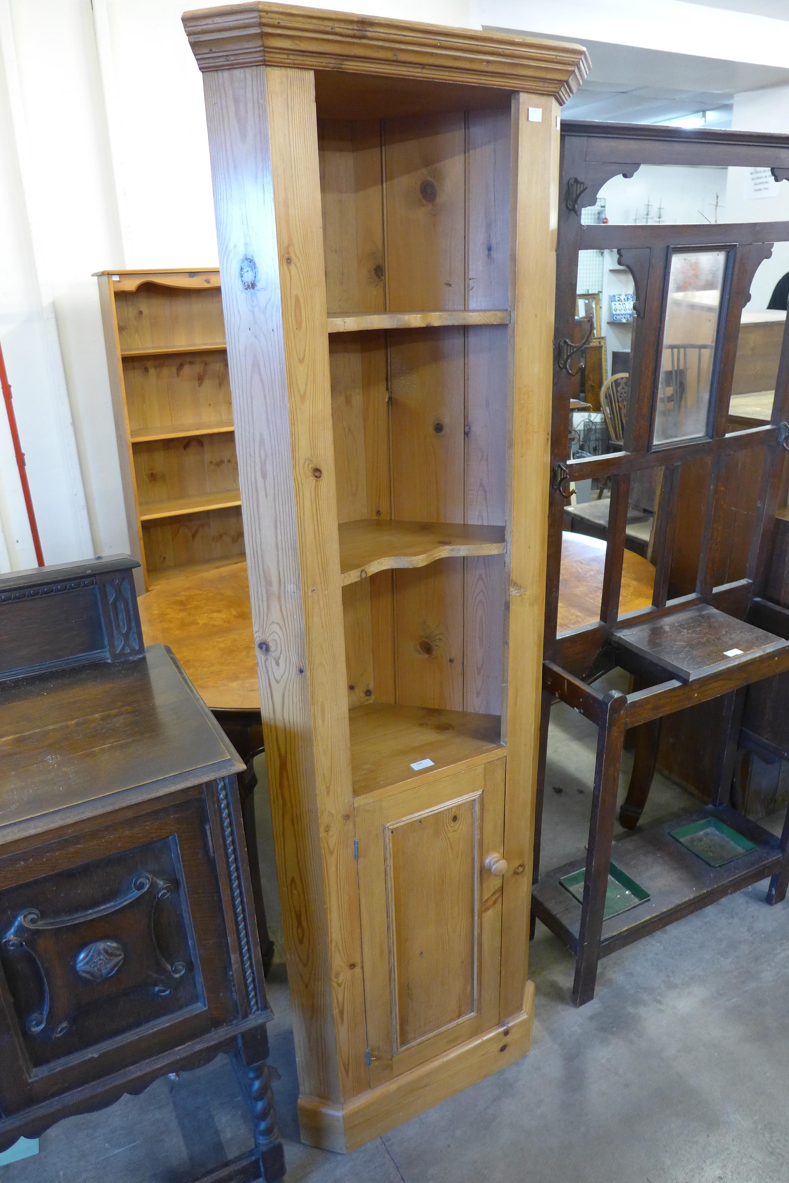 A pine freestanding corner cabinet