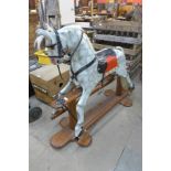 A painted dapple grey child's rocking horse on stand