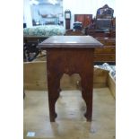 An Arts and Crafts oak jardiniere stand