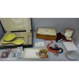 A collection of costume jewellery, a brush and mirror set lacking comb and a storage box