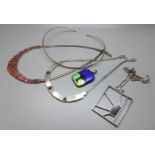 A collection of silver jewellery, fringe necklace, a necklet set with red cabochon stones, pendant