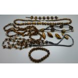 A collection of tigers eye jewellery including necklaces and earrings