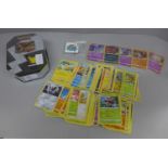 Pokemon cards; a Pokemon collectors tin containing 150 basic Pokemon cards, five holographic cards