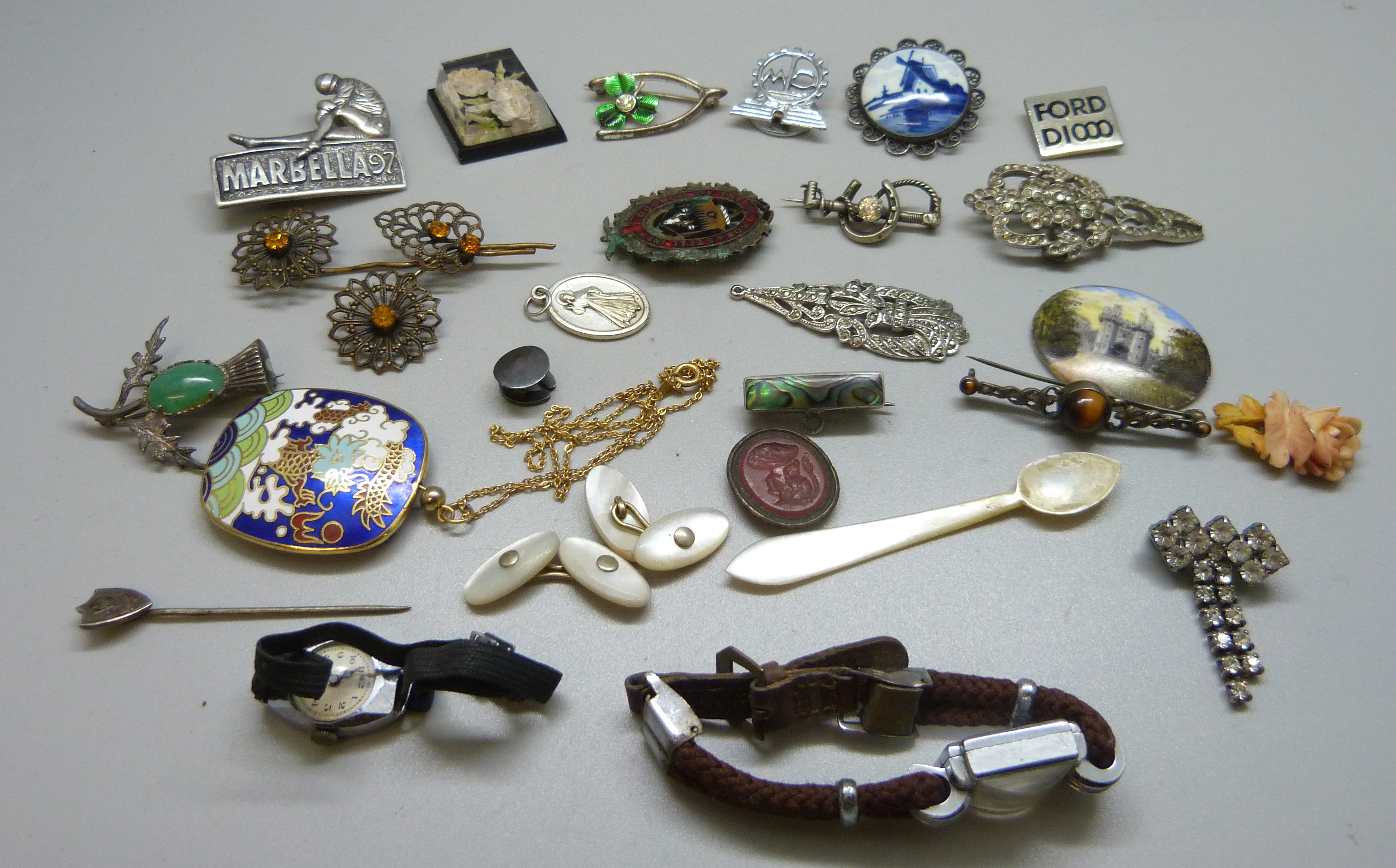 Assorted badges, brooches, wristwatch, etc.